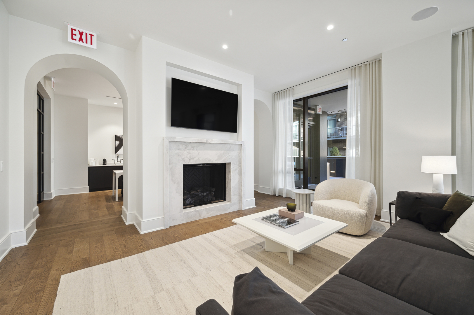 21 North May Street, Unit 1401 Chicago, IL 60607 - Photo 25 of 47 a living room with furniture a flat screen tv and a fireplace