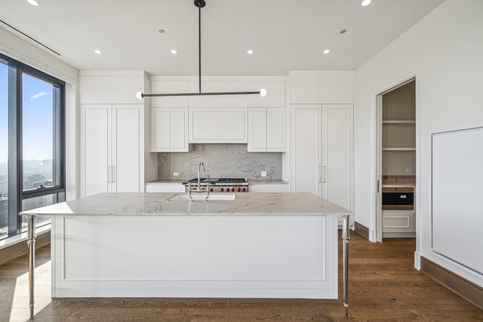 21 North May Street, Unit 1401 Chicago, IL 60607 - Photo 36 of 47 a large kitchen with stainless steel appliances granite countertop a stove a sink and a refrigerator