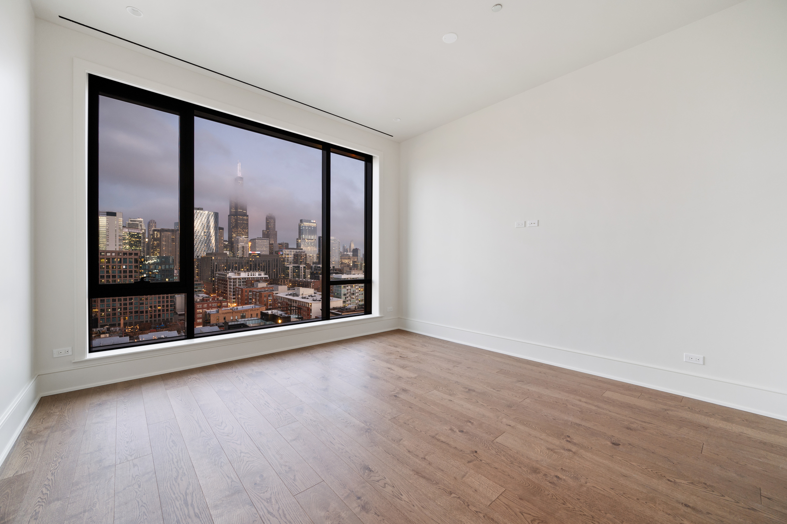 21 North May Street, Unit 1401 Chicago, IL 60607 - Photo 41 of 47 an empty room with wooden floor and windows
