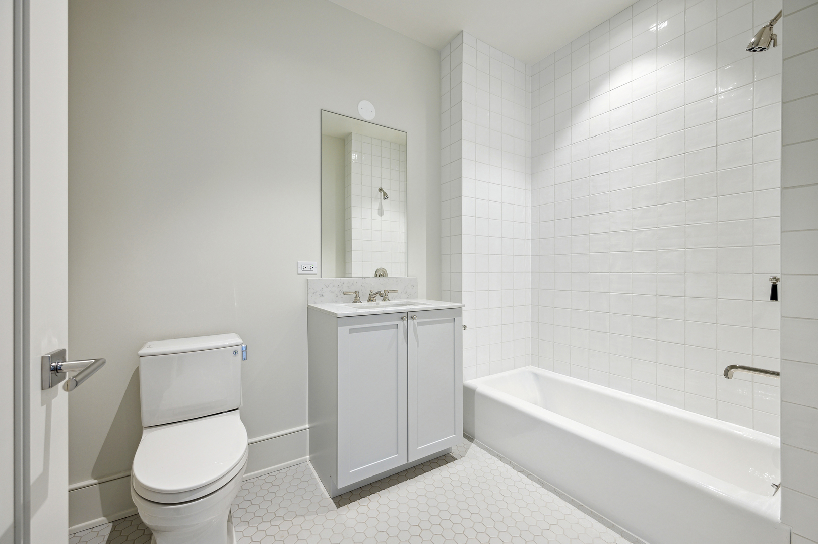 21 North May Street, Unit 1401 Chicago, IL 60607 - Photo 44 of 47 a bathroom with a toilet a sink and bathtub