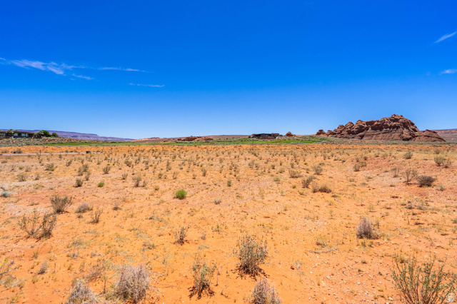 3306 South Endless Trail, Unit 33 Hurricane, UT 84737 - Photo 15 of 27 Expansive desert landscape featuring reddish-orange soil and scattered low-lying vegetation