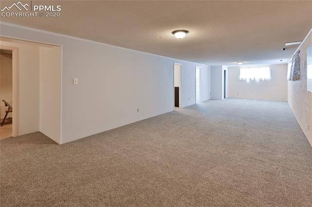 15445 Raton Road Colorado Springs, CO 80921 - Photo 28 of 46 Basement Family Room is long with lots of space