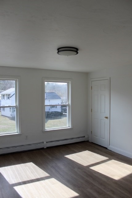 118 South Main Street, Unit 2 Freetown, MA 02702 - Photo 11 of 16 a view of an empty room with wooden floor and a window