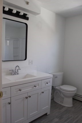 118 South Main Street, Unit 2 Freetown, MA 02702 - Photo 15 of 16 a bathroom with a toilet sink and mirror