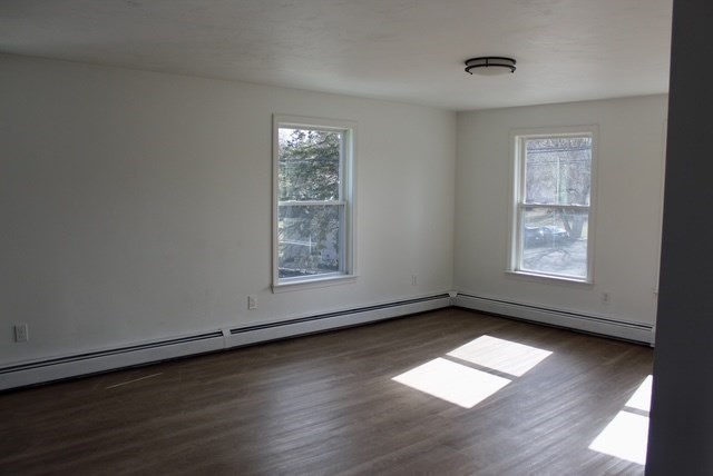 118 South Main Street, Unit 2 Freetown, MA 02702 - Photo 5 of 16 an empty room with wooden floor and windows