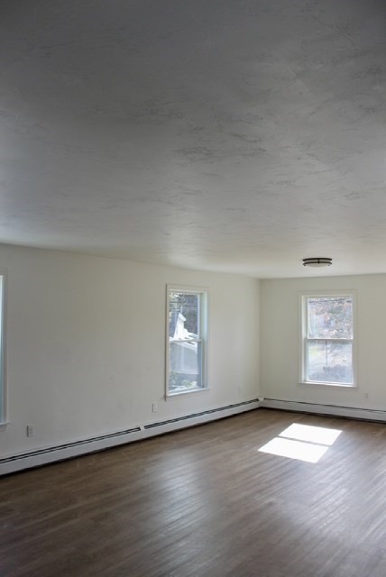 118 South Main Street, Unit 2 Freetown, MA 02702 - Photo 7 of 16 an empty room with wooden floor and windows