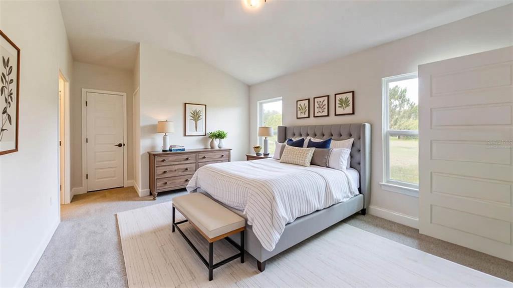 1772 Roberts Trail Bell, FL 32619 - Photo 13 of 26 a spacious bedroom with a bed and a cabinets