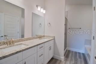 1772 Roberts Trail Bell, FL 32619 - Photo 14 of 26 a bathroom with a granite countertop sink and a mirror