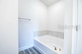1772 Roberts Trail Bell, FL 32619 - Photo 16 of 26 a white bath tub sitting in a bathroom
