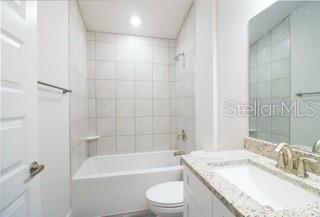 1772 Roberts Trail Bell, FL 32619 - Photo 20 of 26 a bathroom with a granite countertop bathtub shower sink vanity mirror and toilet