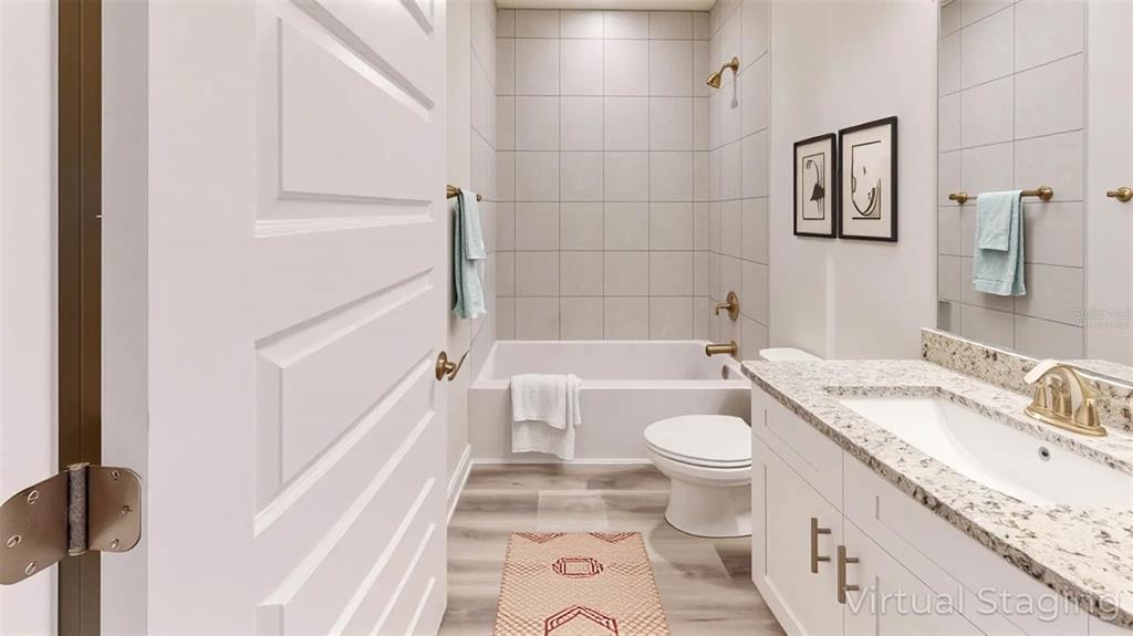 1772 Roberts Trail Bell, FL 32619 - Photo 21 of 26 a bathroom with a granite countertop toilet a sink and a bathtub