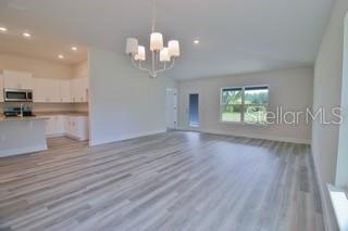 1772 Roberts Trail Bell, FL 32619 - Photo 6 of 26 a view of a room with wooden floors and chandelier