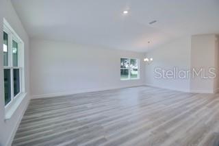 1772 Roberts Trail Bell, FL 32619 - Photo 7 of 26 wooden floor in an empty room with a window