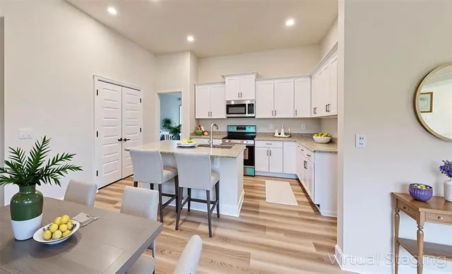 a kitchen with stainless steel appliances kitchen island granite countertop lots of counter top space and furniture