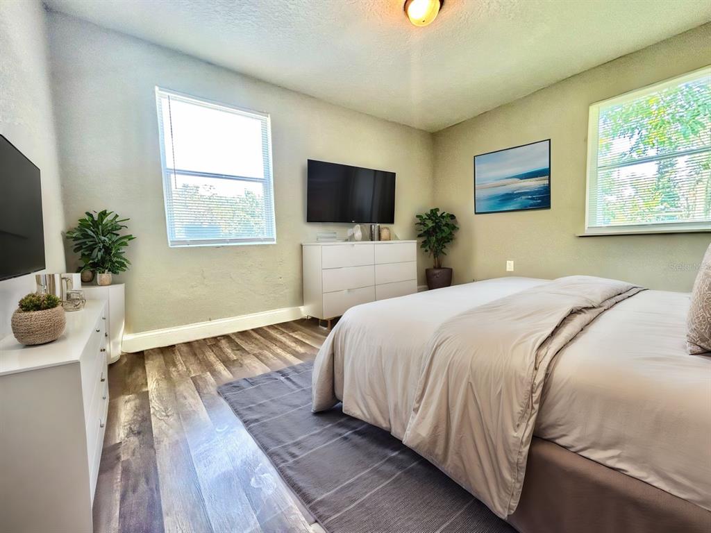 418 Charles Street Winter Garden, FL 34787 - Photo 15 of 27 a bedroom with a bed and a flat screen tv