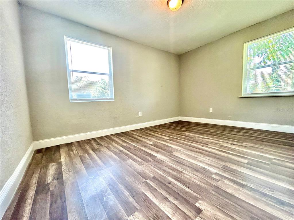 418 Charles Street Winter Garden, FL 34787 - Photo 16 of 27 an empty room with wooden floor and windows