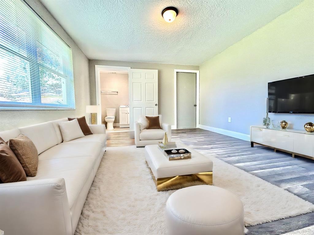 418 Charles Street Winter Garden, FL 34787 - Photo 20 of 27 a living room with furniture and a flat screen tv