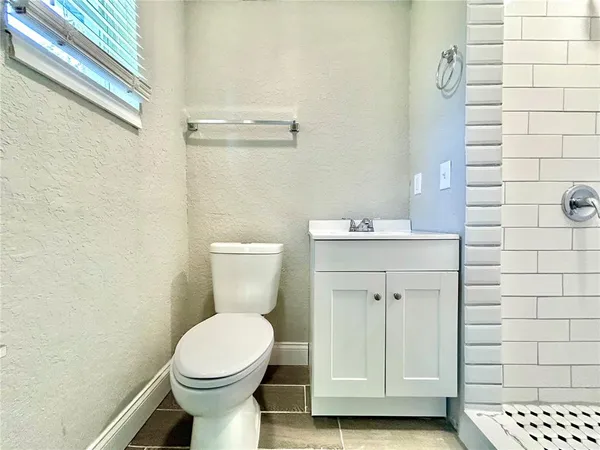 a bathroom with a toilet sink and shower