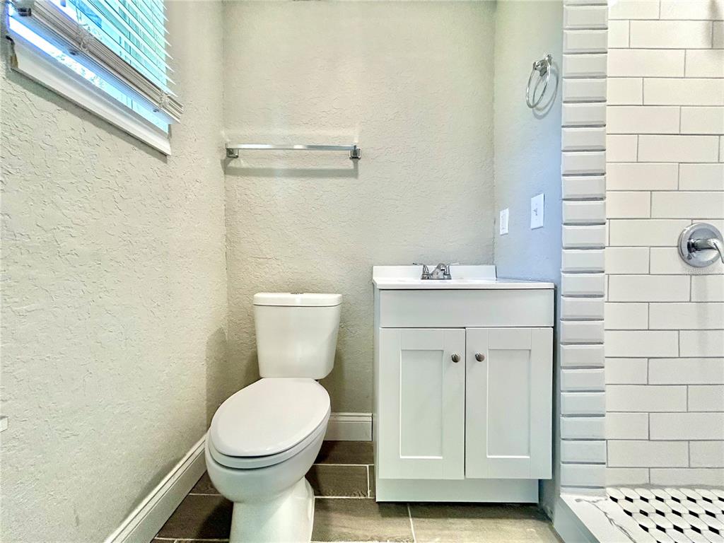 418 Charles Street Winter Garden, FL 34787 - Photo 22 of 27 a bathroom with a toilet sink and shower