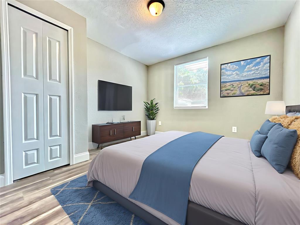 418 Charles Street Winter Garden, FL 34787 - Photo 30 of 35 a bedroom with a bed and a flat screen tv