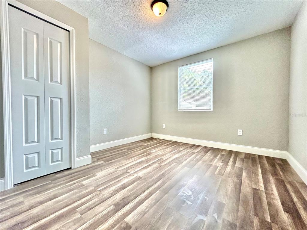 418 Charles Street Winter Garden, FL 34787 - Photo 31 of 35 a view of an empty room with wooden floor and a window
