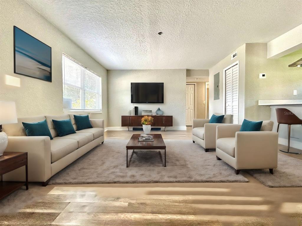 418 Charles Street Winter Garden, FL 34787 - Photo 4 of 27 a living room with furniture and a flat screen tv