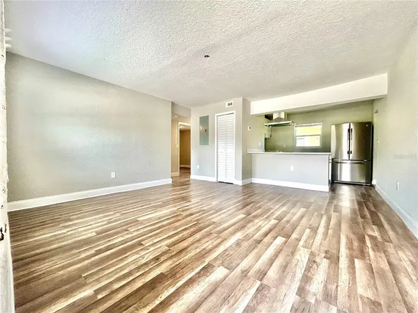 a view of a big room with wooden floor and natural light