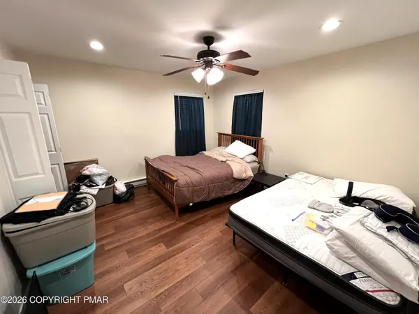 a bedroom with bed and a chandelier