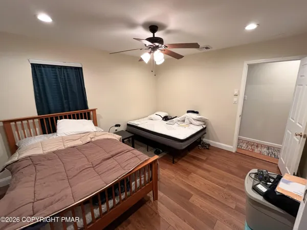 a bedroom with bed and a mirror