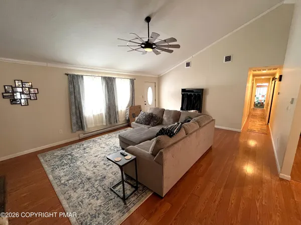 a living room with furniture and a flat screen tv