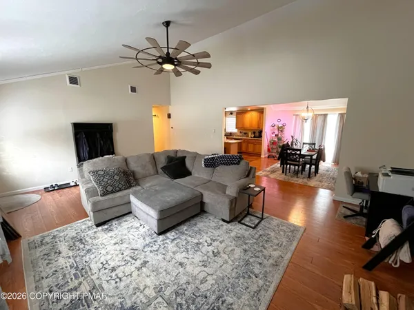a living room with furniture and a flat screen tv