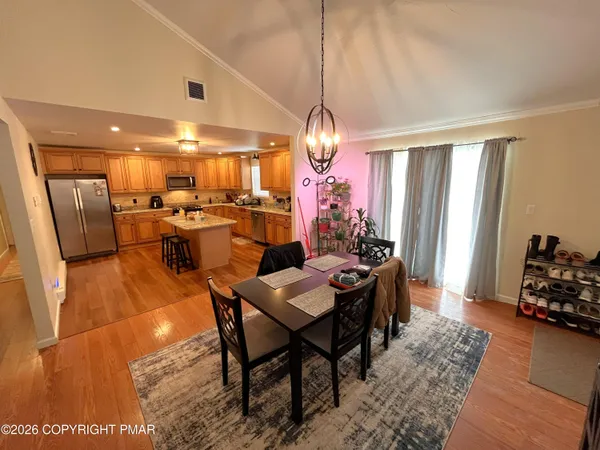 a view of a dining room with furniture and wooden floor