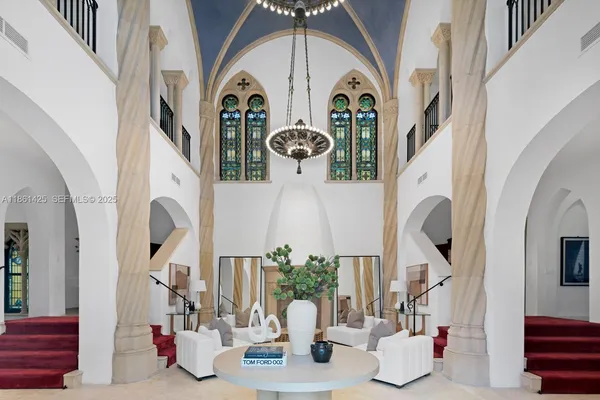 a living room with furniture a chandelier and a chandelier