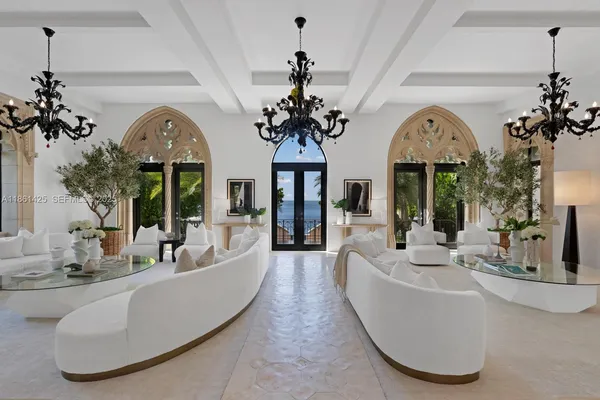 a view of living room with granite countertop a sink and a large mirror