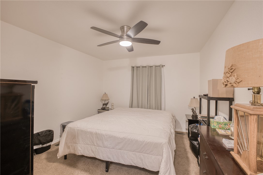 1855 Talc Road Bullhead City, AZ 86442 - Photo 11 of 23 Carpeted bedroom featuring ceiling fan and baseboards