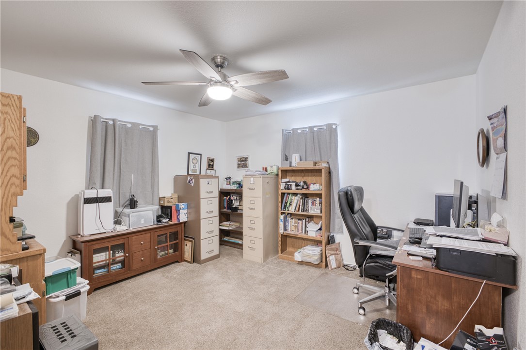 1855 Talc Road Bullhead City, AZ 86442 - Photo 14 of 23 Home office with light carpet and ceiling fan