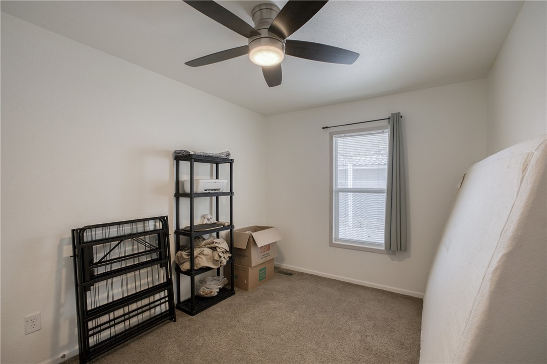 1855 Talc Road Bullhead City, AZ 86442 - Photo 16 of 23 Carpeted spare room with baseboards and ceiling fan