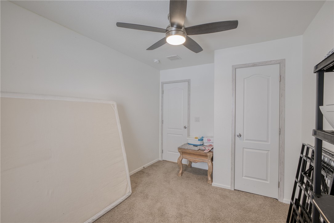1855 Talc Road Bullhead City, AZ 86442 - Photo 17 of 23 Bedroom with light colored carpet and a ceiling fan