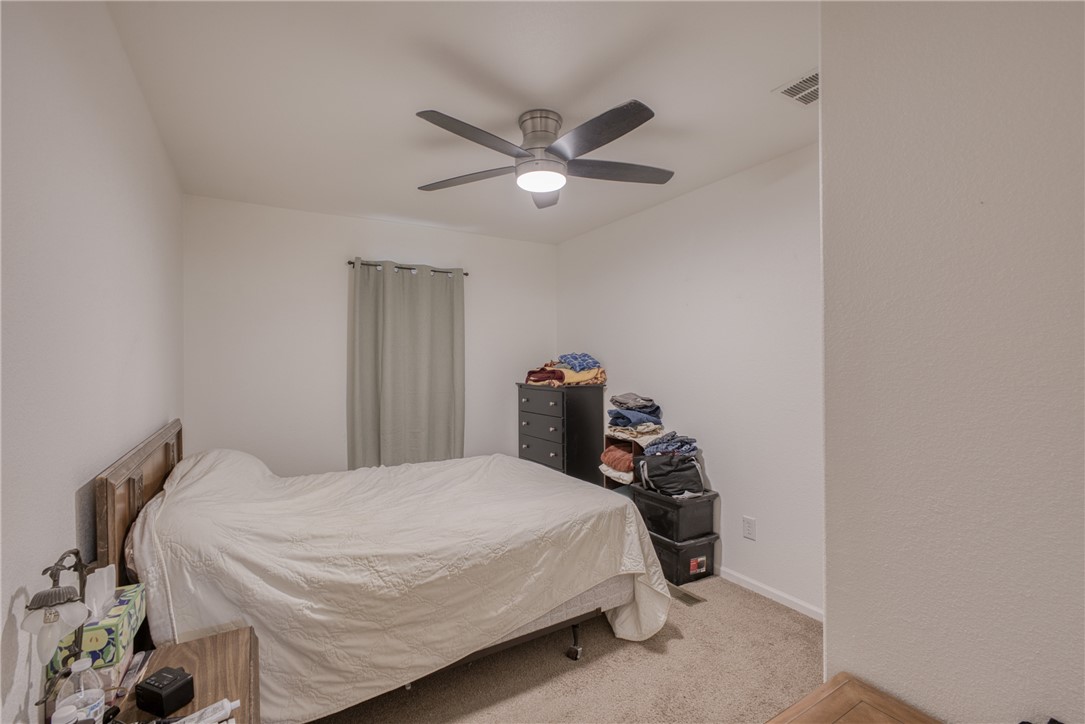 1855 Talc Road Bullhead City, AZ 86442 - Photo 18 of 23 Bedroom featuring light colored carpet and a ceiling fan