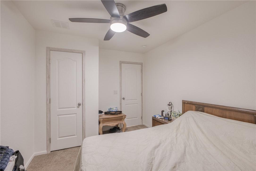 1855 Talc Road Bullhead City, AZ 86442 - Photo 19 of 23 Bedroom featuring light carpet and a ceiling fan