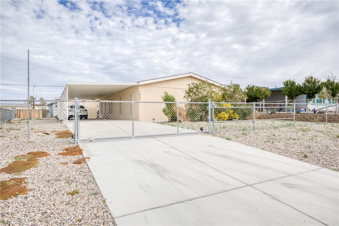 1855 Talc Road Bullhead City, AZ 86442 - Photo 2 of 23 Manufactured / mobile home with a carport, concrete driveway, and a gate