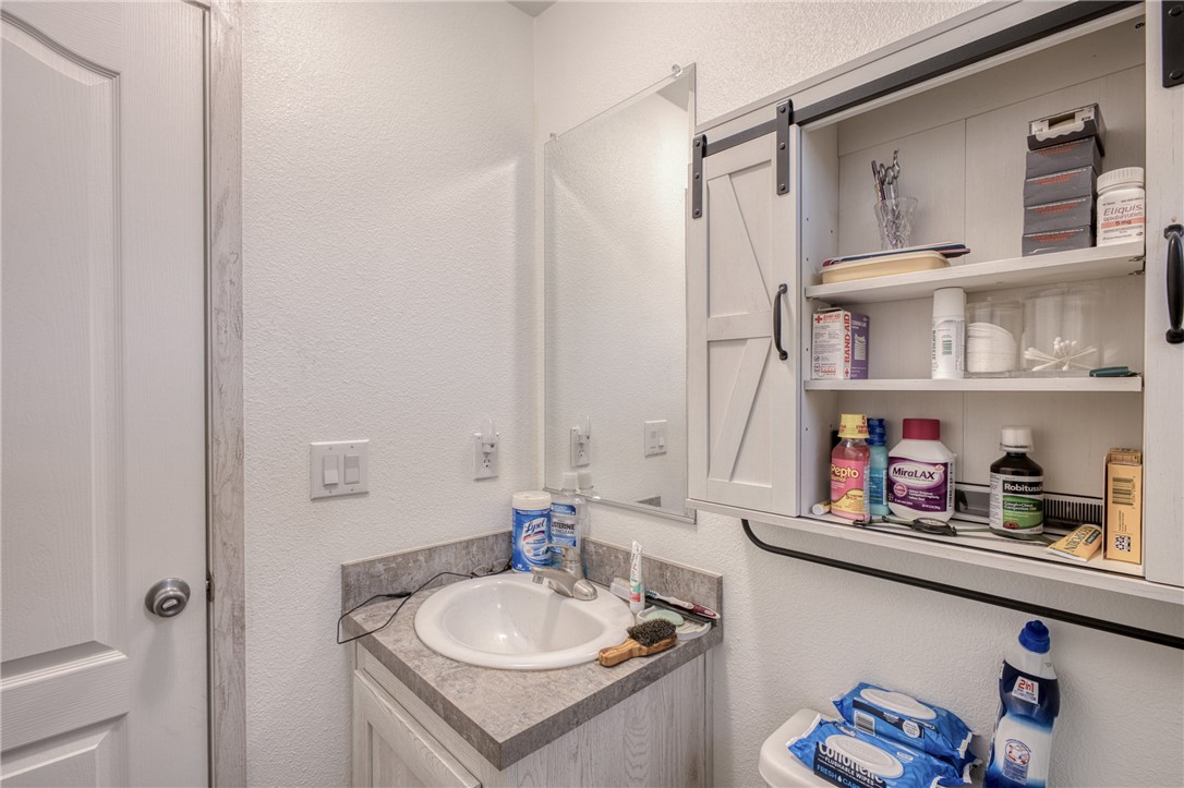 1855 Talc Road Bullhead City, AZ 86442 - Photo 21 of 23 Half bathroom with a textured wall and vanity