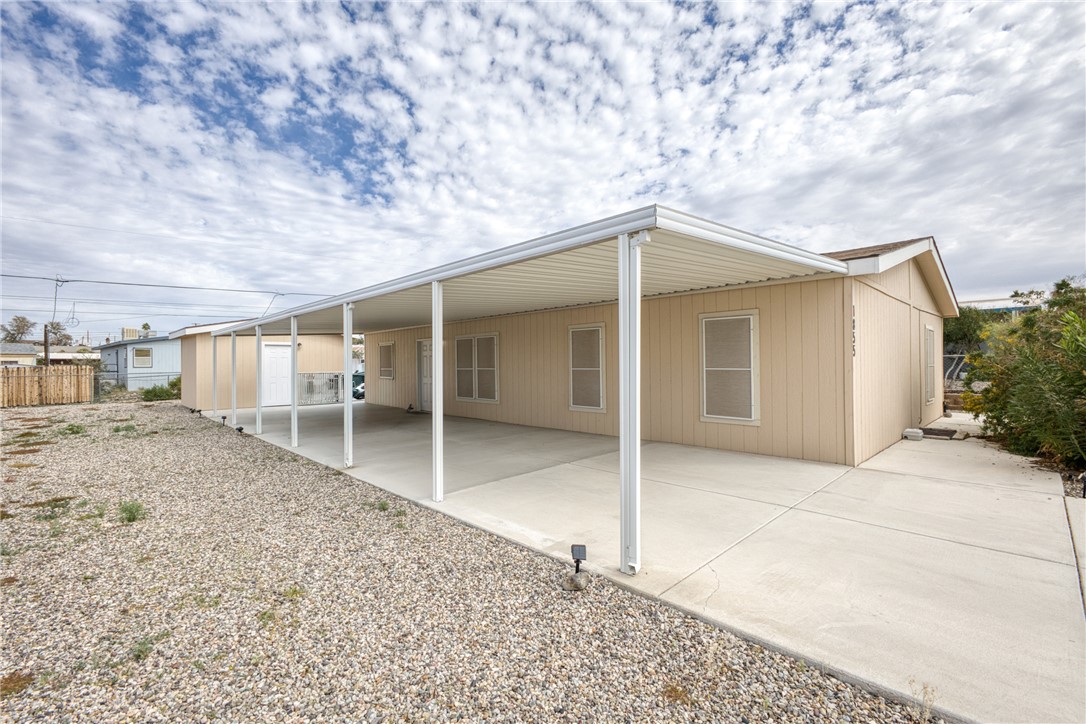 1855 Talc Road Bullhead City, AZ 86442 - Photo 4 of 23 Back of house featuring an attached carport and a patio area
