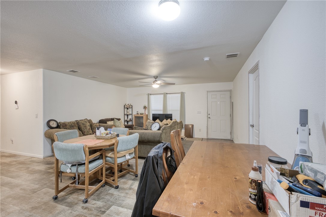 1855 Talc Road Bullhead City, AZ 86442 - Photo 8 of 23 Dining room with a ceiling fan and a textured ceiling