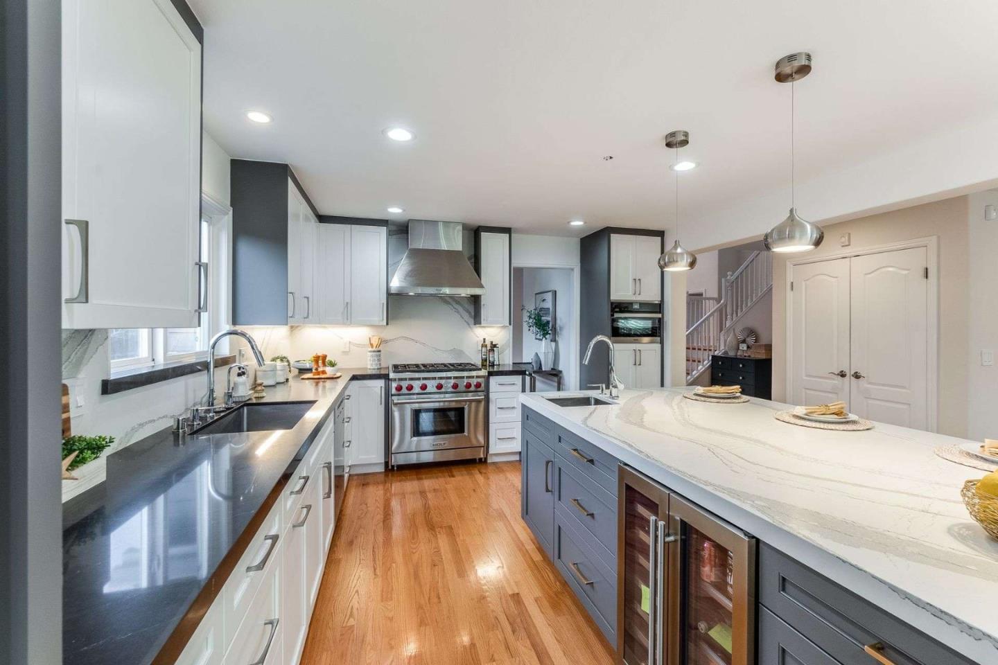 735 Sleeper Avenue Mountain View, CA 94040 - Photo 14 of 77 a large kitchen with stainless steel appliances lots of counter space and wooden floor