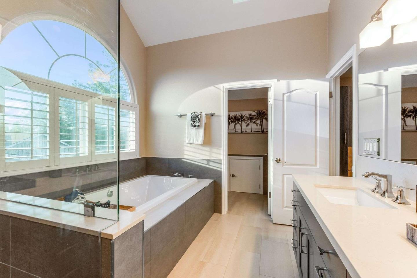 735 Sleeper Avenue Mountain View, CA 94040 - Photo 37 of 77 a bathroom with a tub a sink and a large mirror