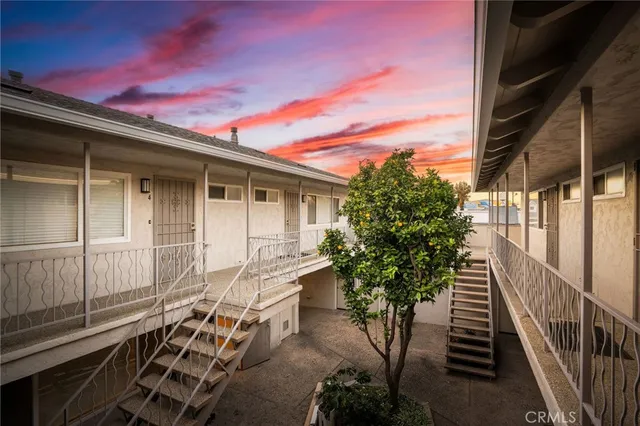 a backyard of a house with table and chairs