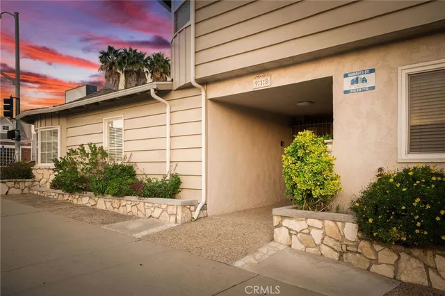 a front view of a house with a yard and outdoor seating