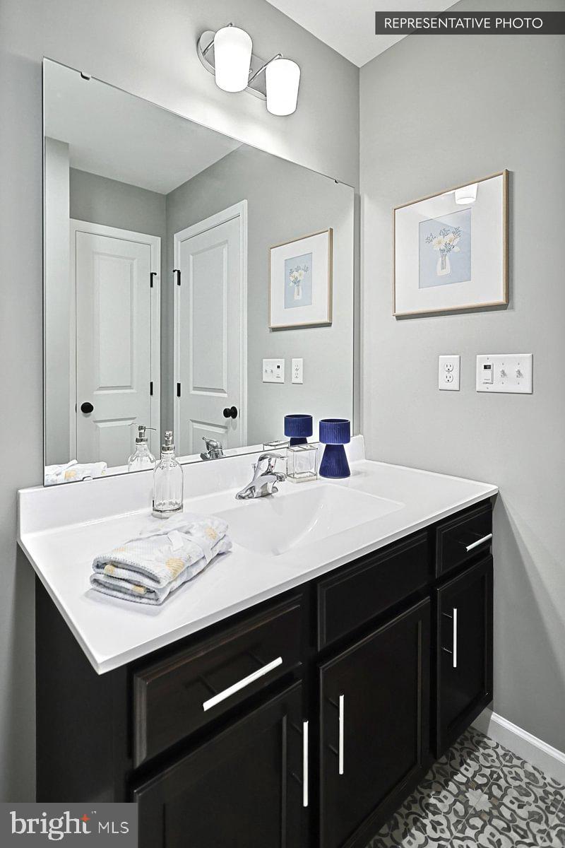 Sweet Birch Plan At Hills Spring Grove, PA 17362 - Photo 34 of 47 a bathroom with a sink vanity and a mirror