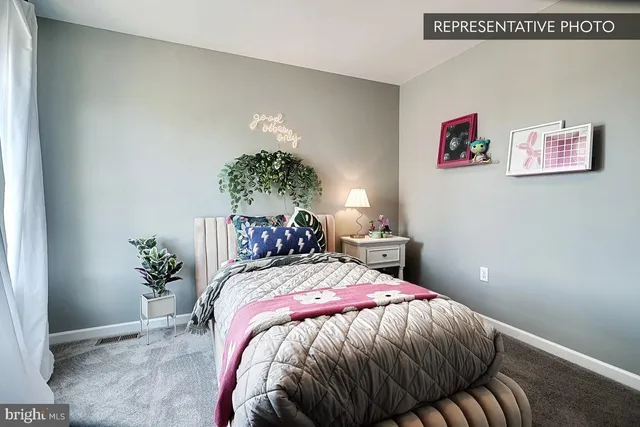 a bed sitting in a bedroom and painting on the wall